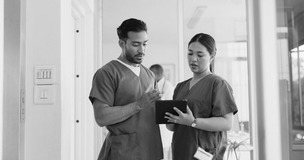 Two nurses looking at tablet